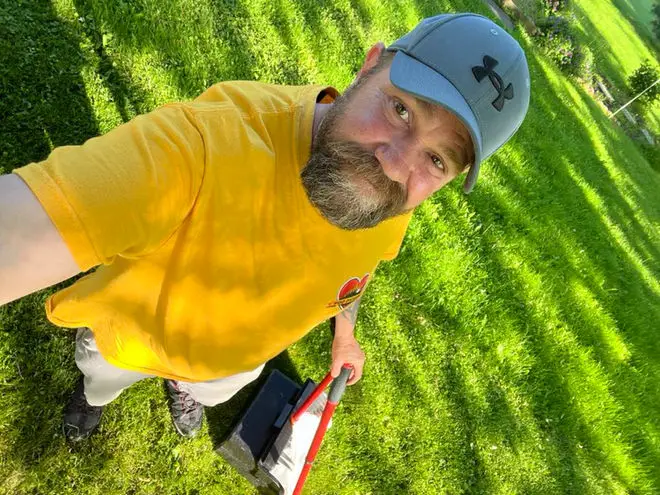 Rich, owner of Poo Pickers Ohio, with his dog in a clean residential yard