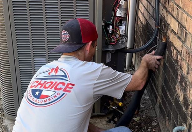 Technician in a 1st Choice uniform inspecting an outdoor AC unit