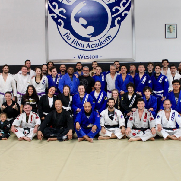 A diverse group of dedicated martial artists practicing advanced techniques at Renzo Gracie Jiu-Jitsu Academy of Weston, featuring seven accomplished black belts proudly wearing their rank, as they train alongside enthusiastic beginners and intermediate practitioners, creating a thriving and inclusive environment for personal growth and skill development in the art of Brazilian Jiu-Jitsu.
