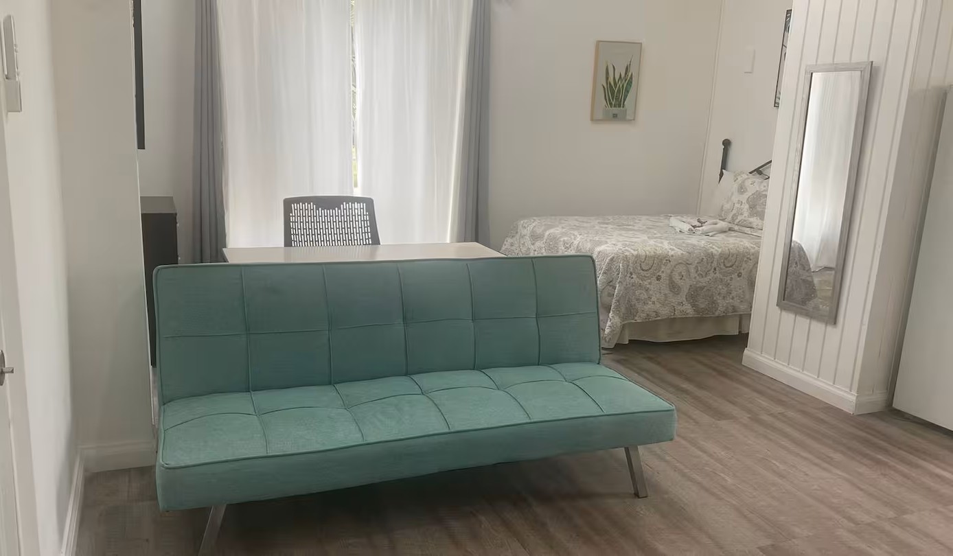 Clean Studio Layout with High Ceilings & Sofa