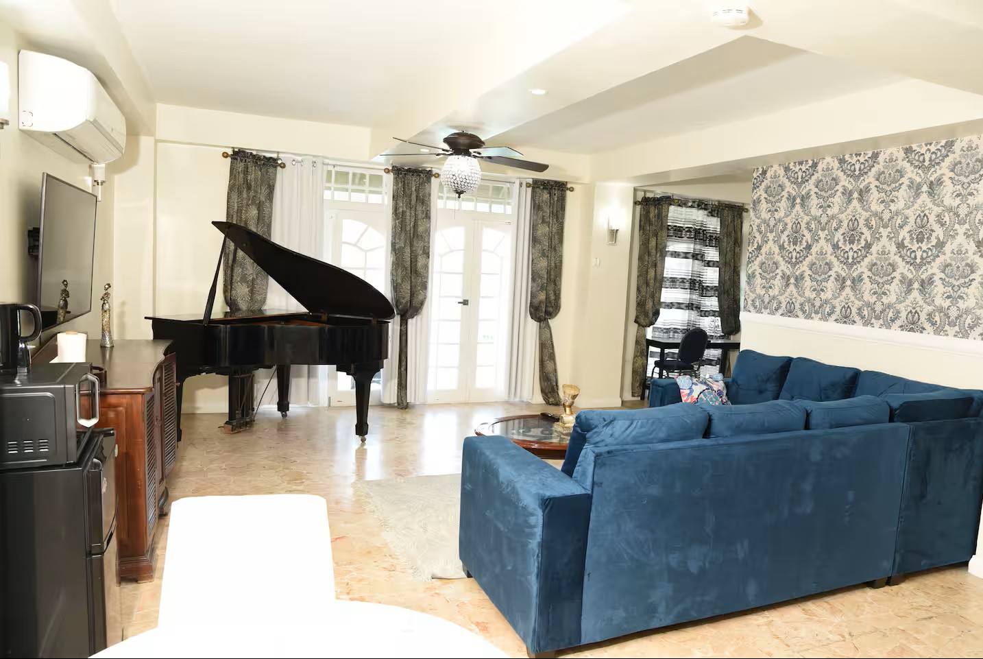 Spacious Master Bedroom with Plush Bed & Coastal Decor