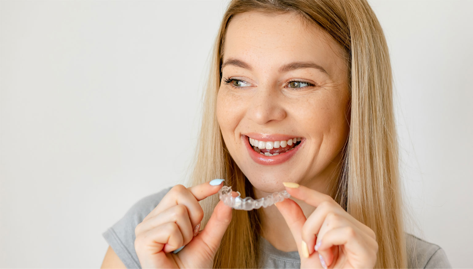 Woman holding invisalign