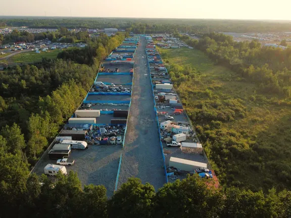Aerial view at sunset of a Longyards facility with fenced yards on both sides of a central lane
