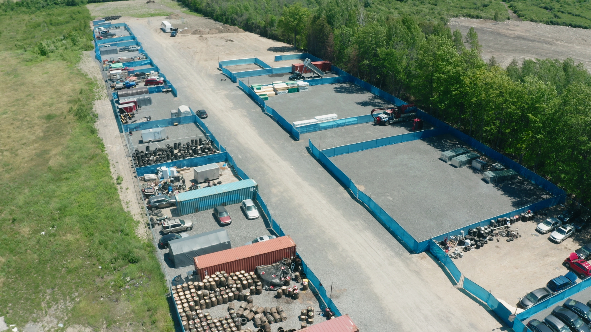 Aerial view of fenced Longyards yards along a wide gravel access lane
