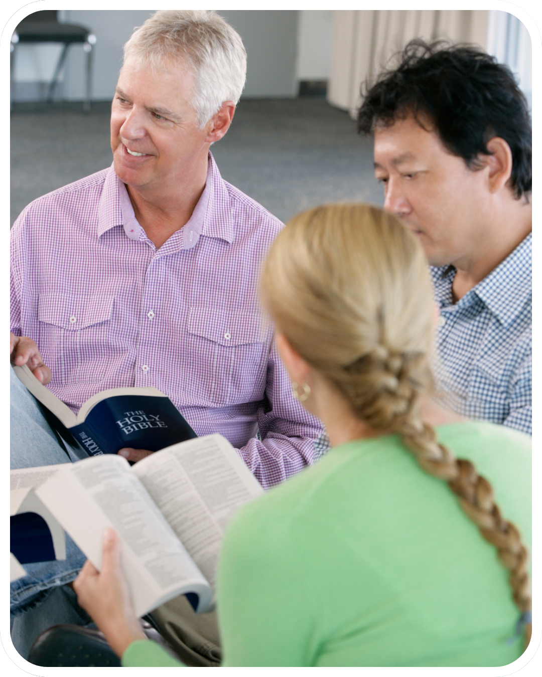 Pastor or ministry leader thoughtfully studying Scripture at a desk.