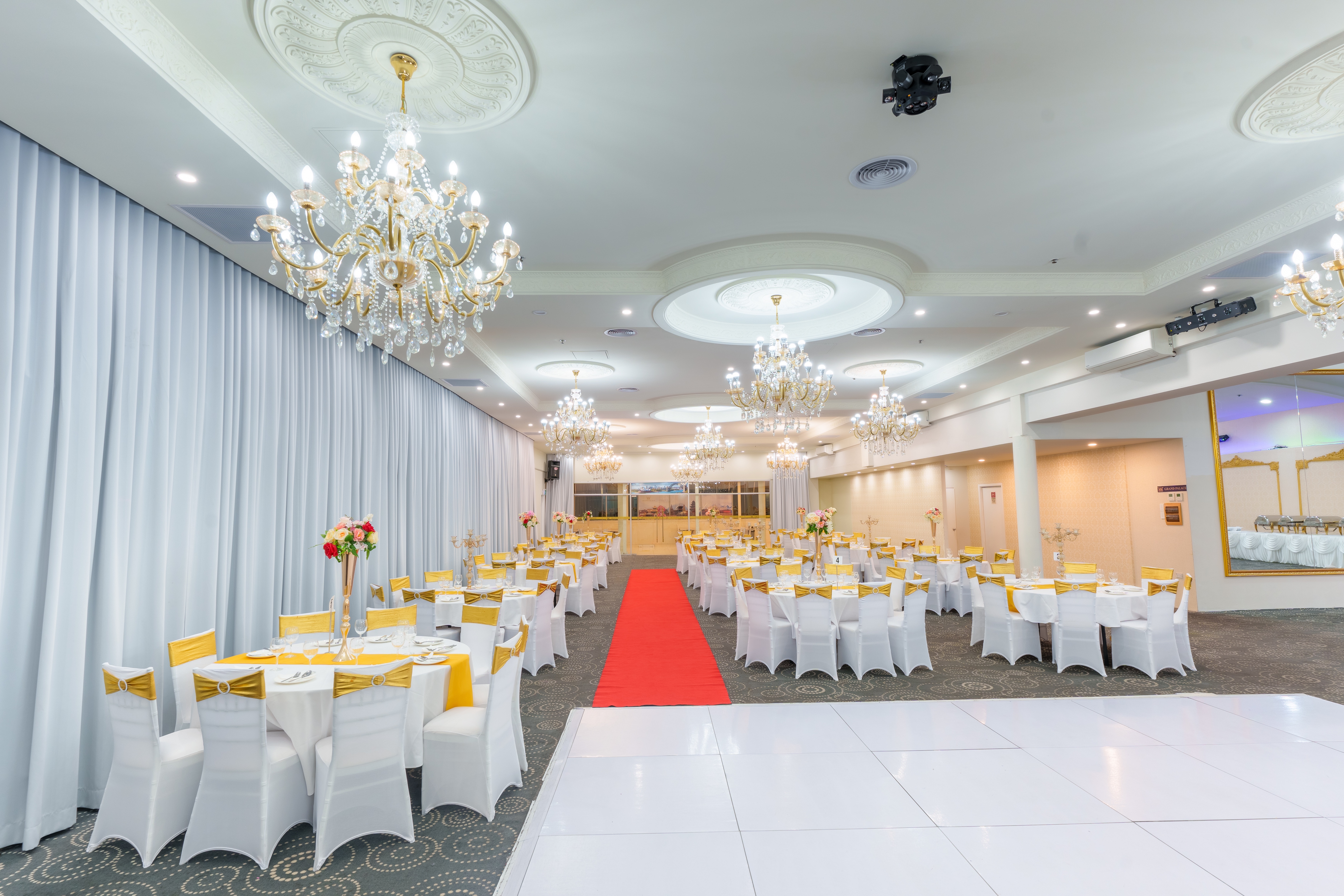 Golden Hall at Grand Palace Function Centre with chandeliers, banquet seating and an open dance floor.