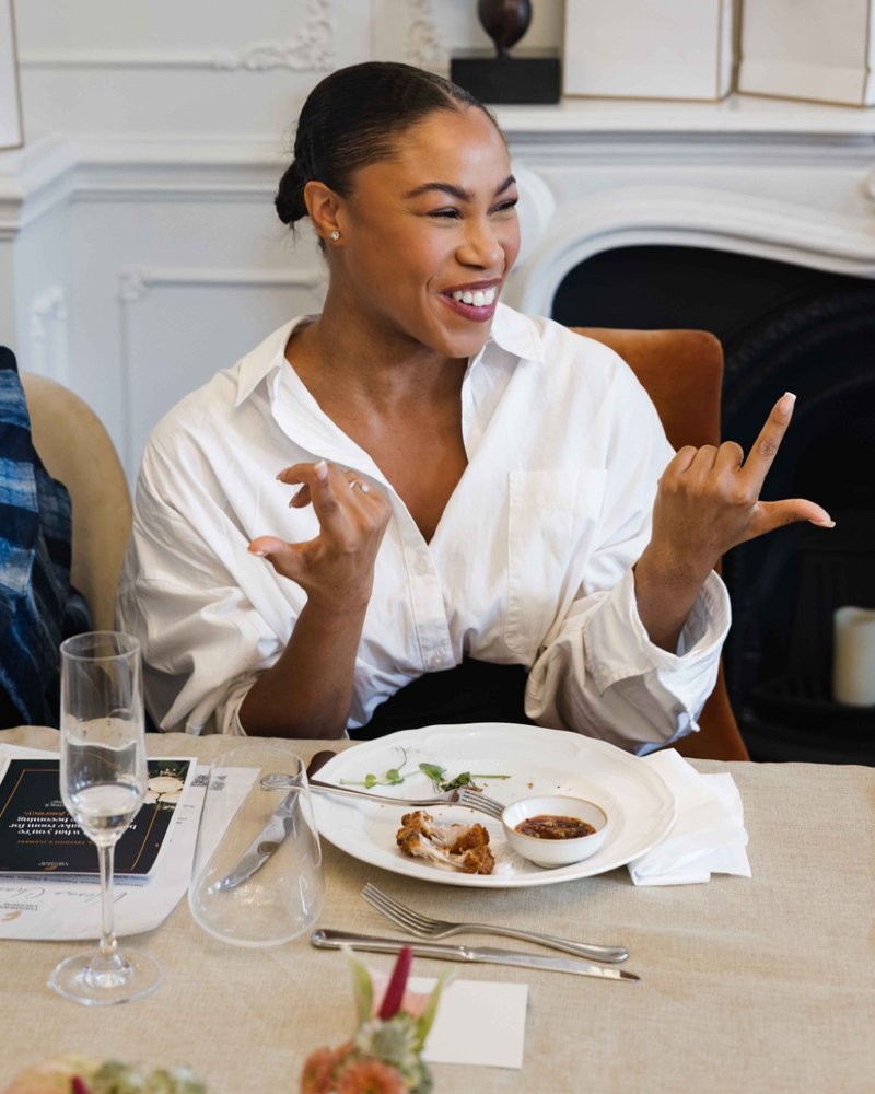 A founder laughing in a white shirt at a Founders Freedom gathering