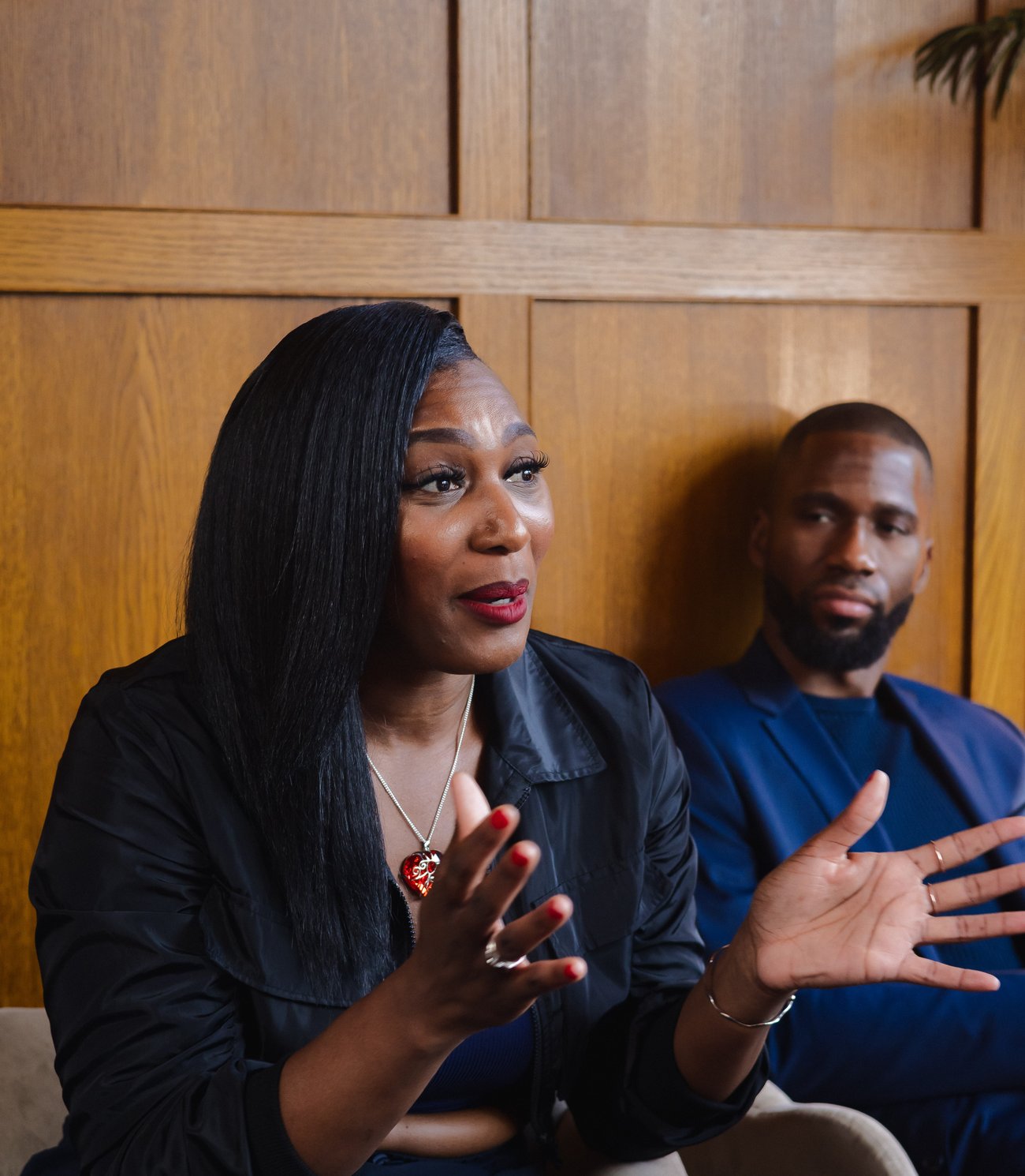 Two founders in conversation in a wood-panelled room at a Founders Freedom gathering