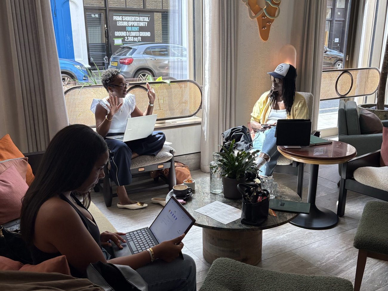 Founders working on laptops in a bright lounge during a Founders Freedom Create day