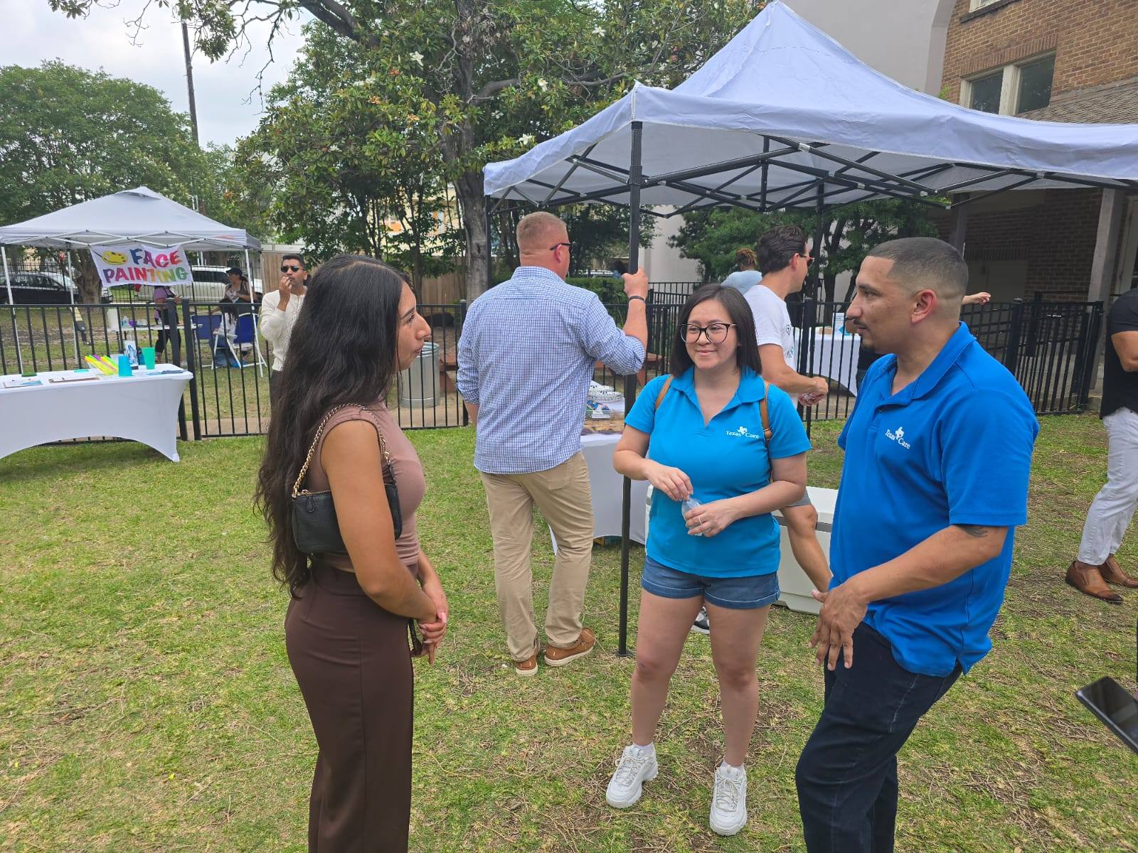 texas care employees speaking with a woman