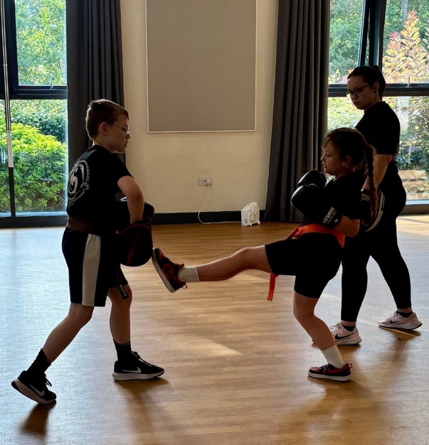 Impact Martial Arts students training together.