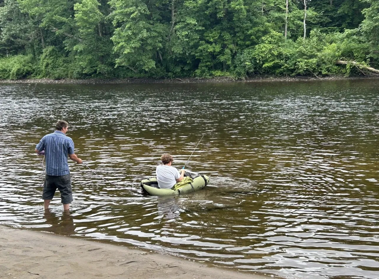 Two anglers fishing West Canada Creek by wading and float tube near West Canada Creek Campground in Poland NY