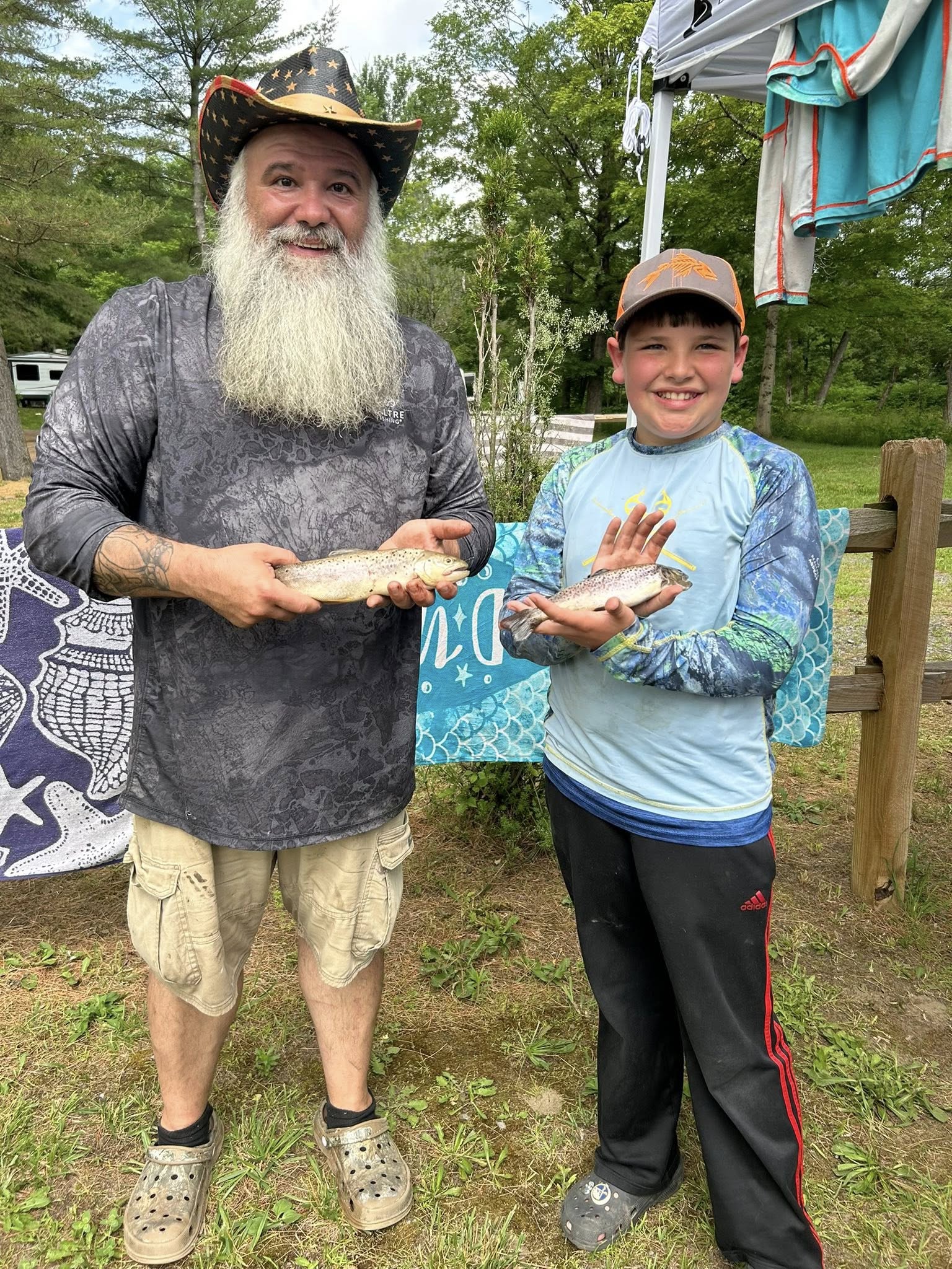 Father and son holding brown trout caught at West Canada Creek Campground in Poland NY