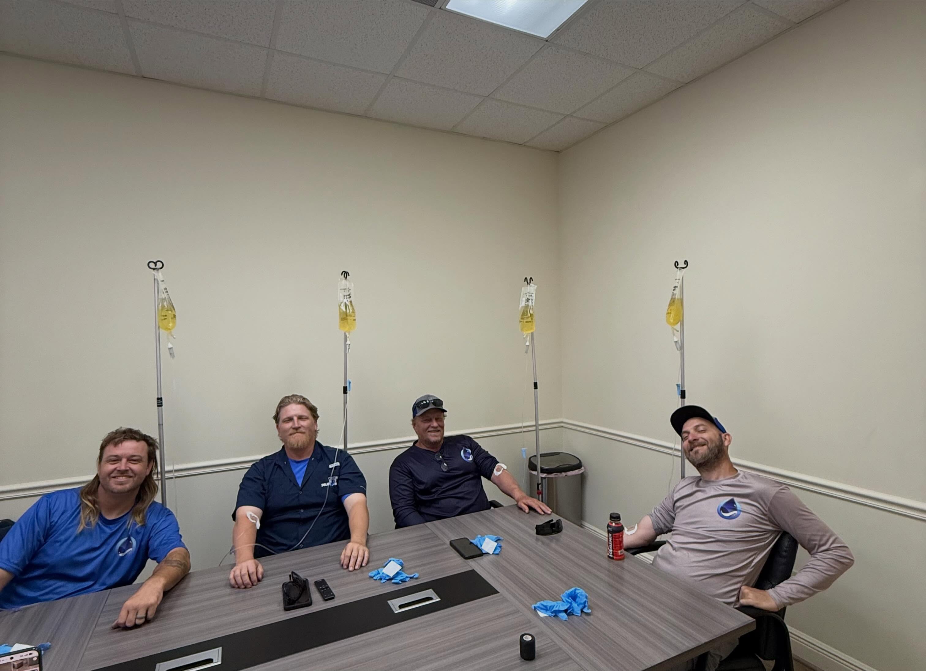 Group of coworkers receiving mobile IV therapy together at their office