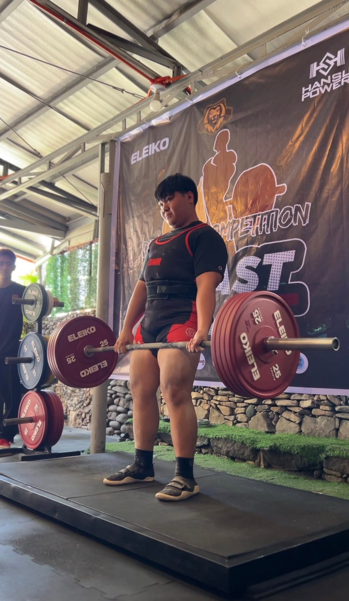 A lifter holding a loaded barbell