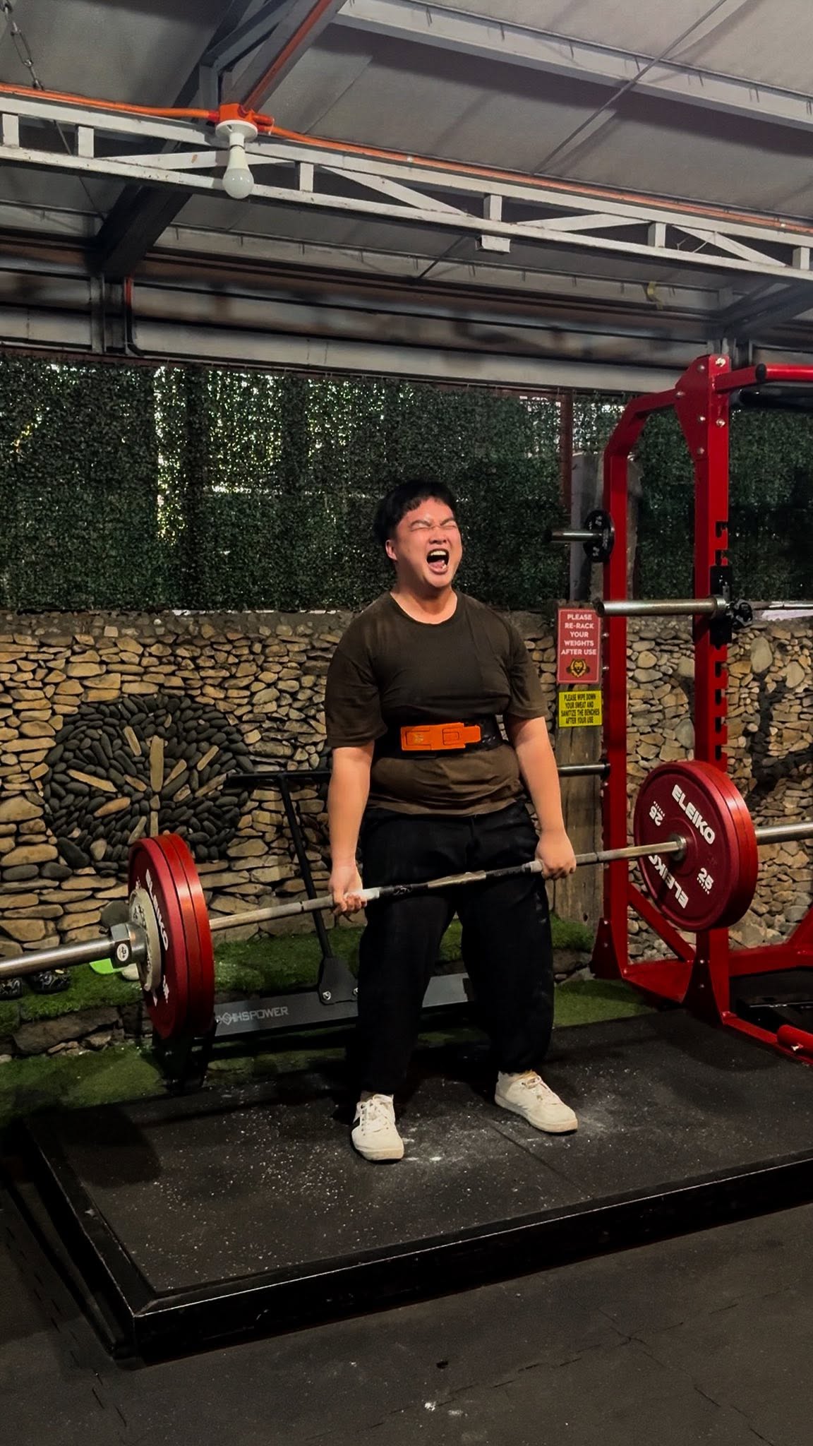 Member lifting a barbell at BeastCave