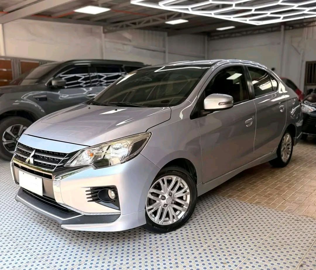 Actual silver Mitsubishi Mirage G4 available from XyRentals, front three-quarter view