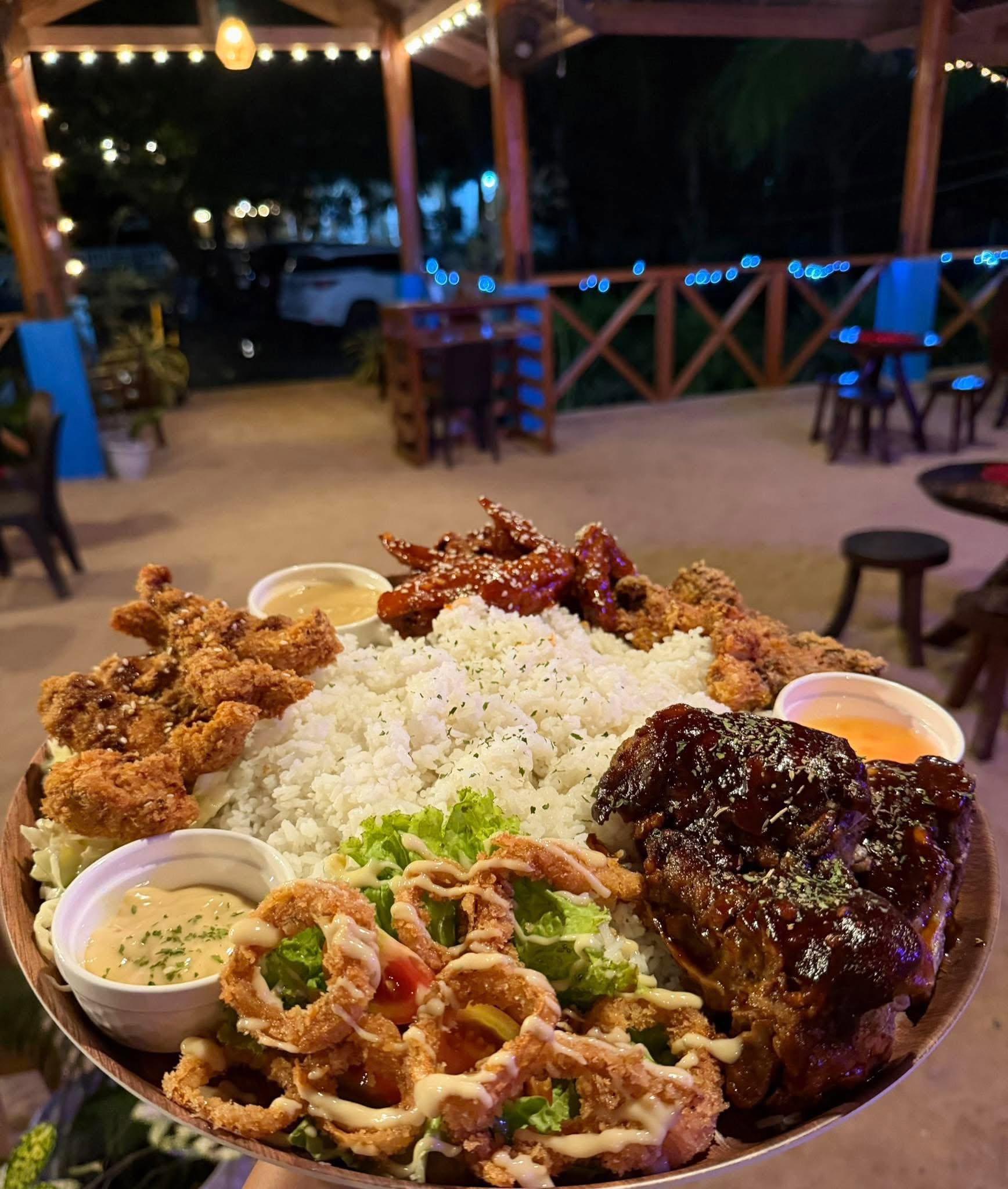 Generous sharing platter of rice, grilled and crispy specialties