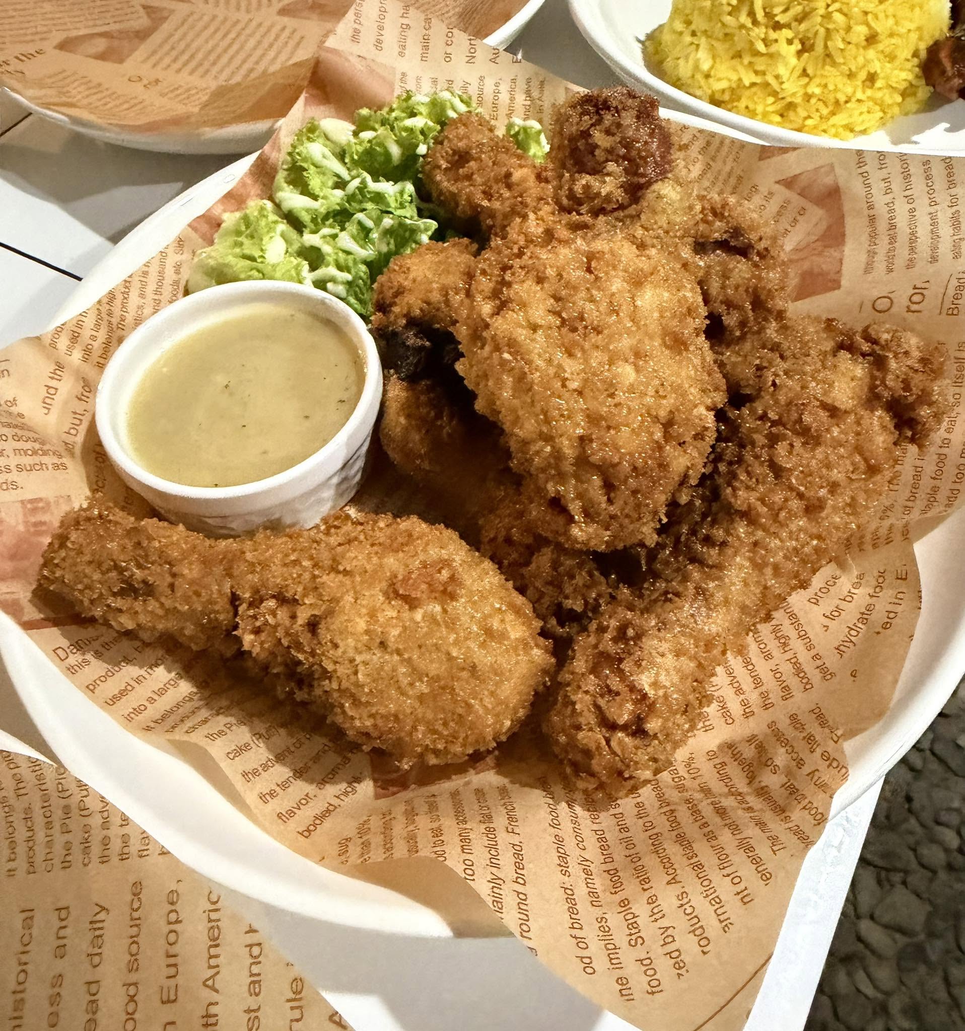 Platter of golden crunchy fried food with creamy dipping sauce