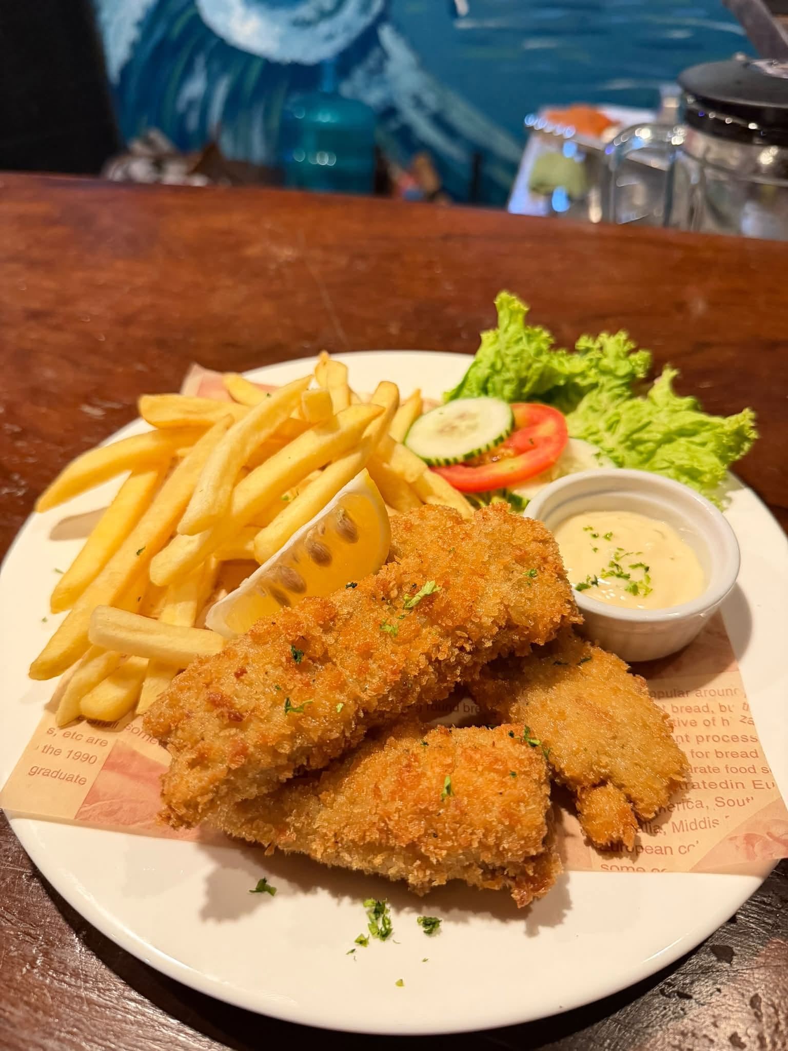Crispy breaded food with fries and dipping sauce