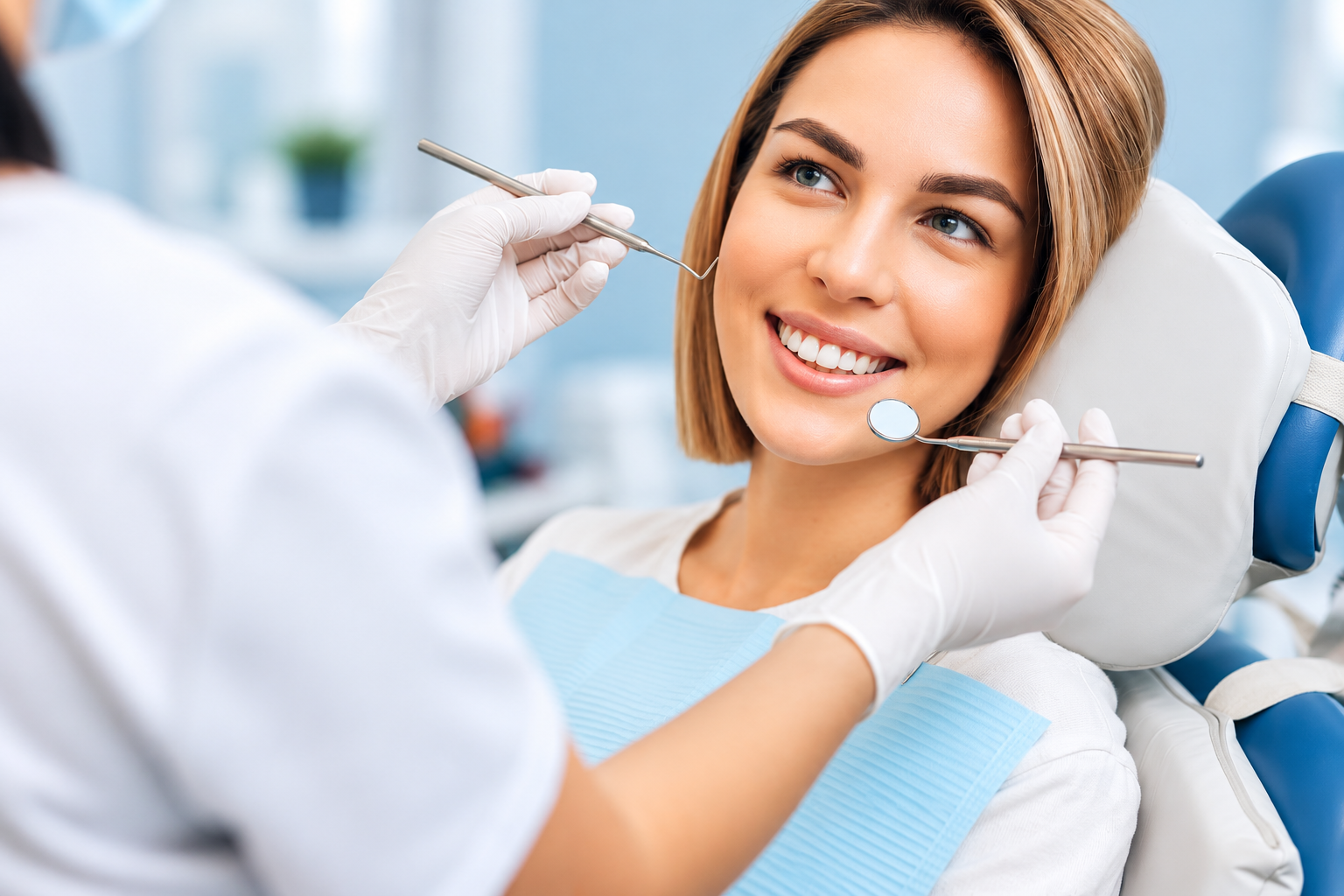 Smiling patient receiving a dental examination
