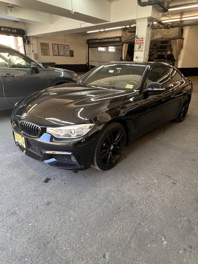 Black vehicle photographed at an automotive workshop