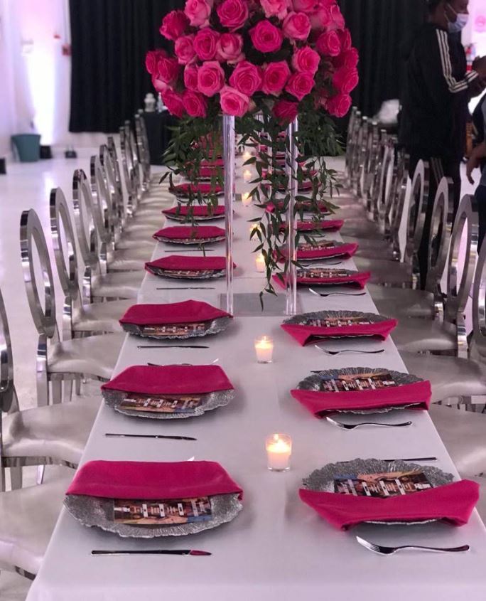 A celebration table set with pink flowers and coordinated place settings