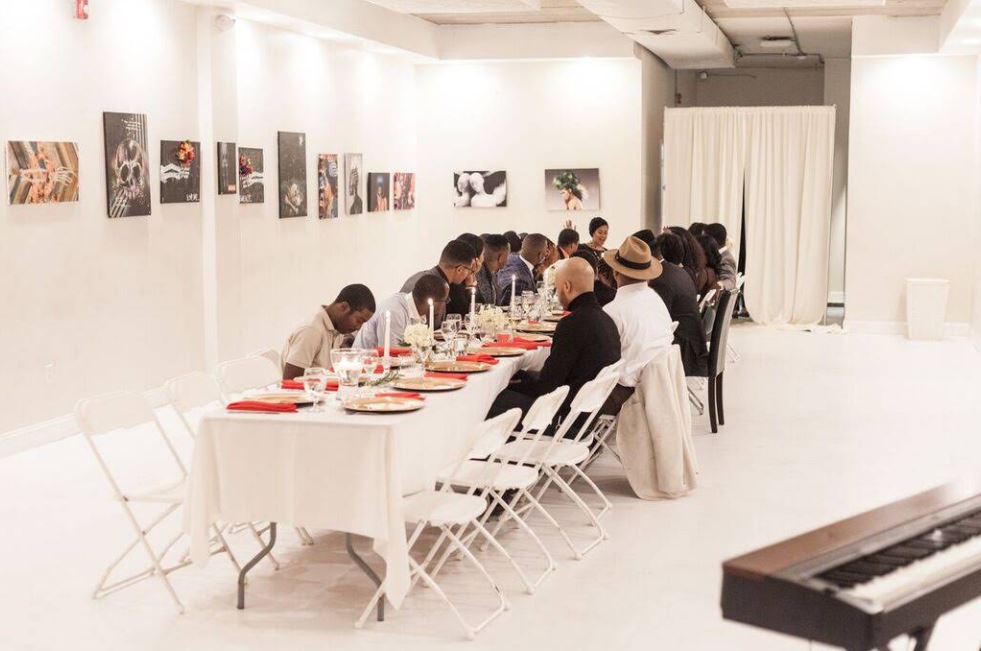 Guests sharing a long-table dinner at the venue