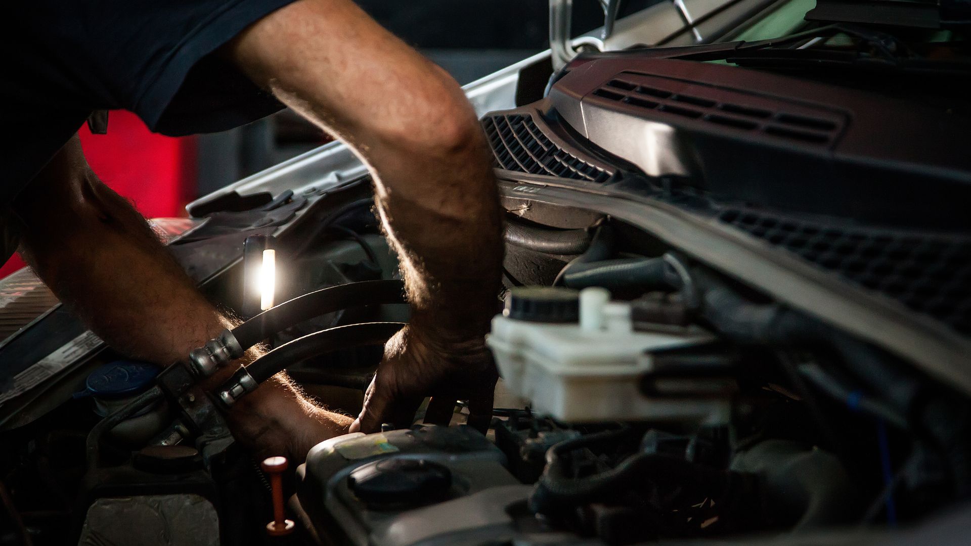 Technician inspecting a vehicle at JC Auto Repair Shop