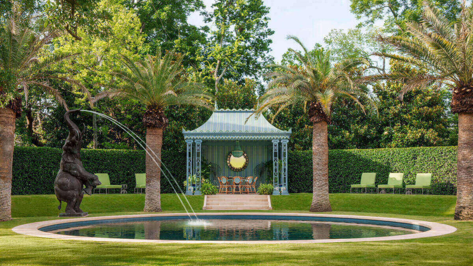 Garden pavilion beside a pool with palms and lawn — outdoor living by Oak and Stone Landscaping