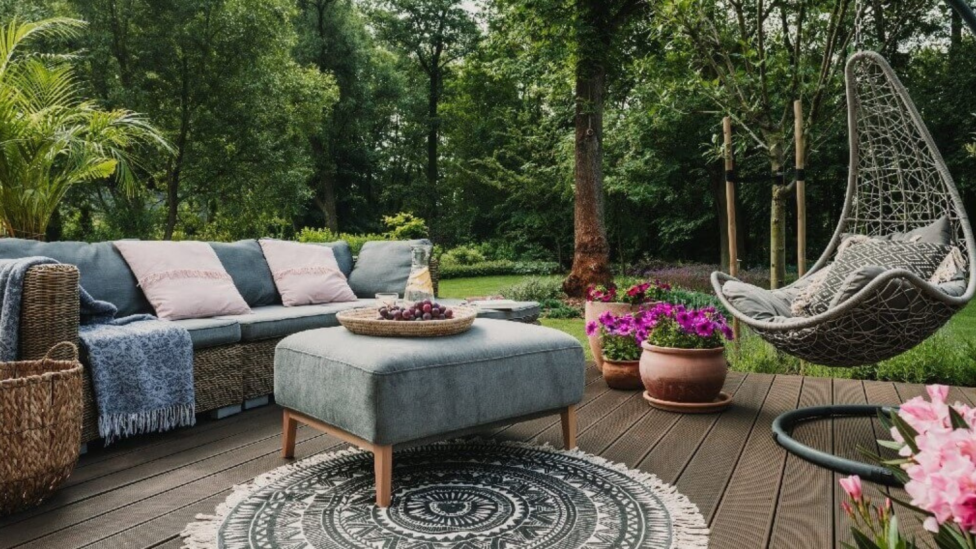 Oak and Stone Landscaping outdoor living area with lounge seating and a fire table, framed by planting in the Sacramento area
