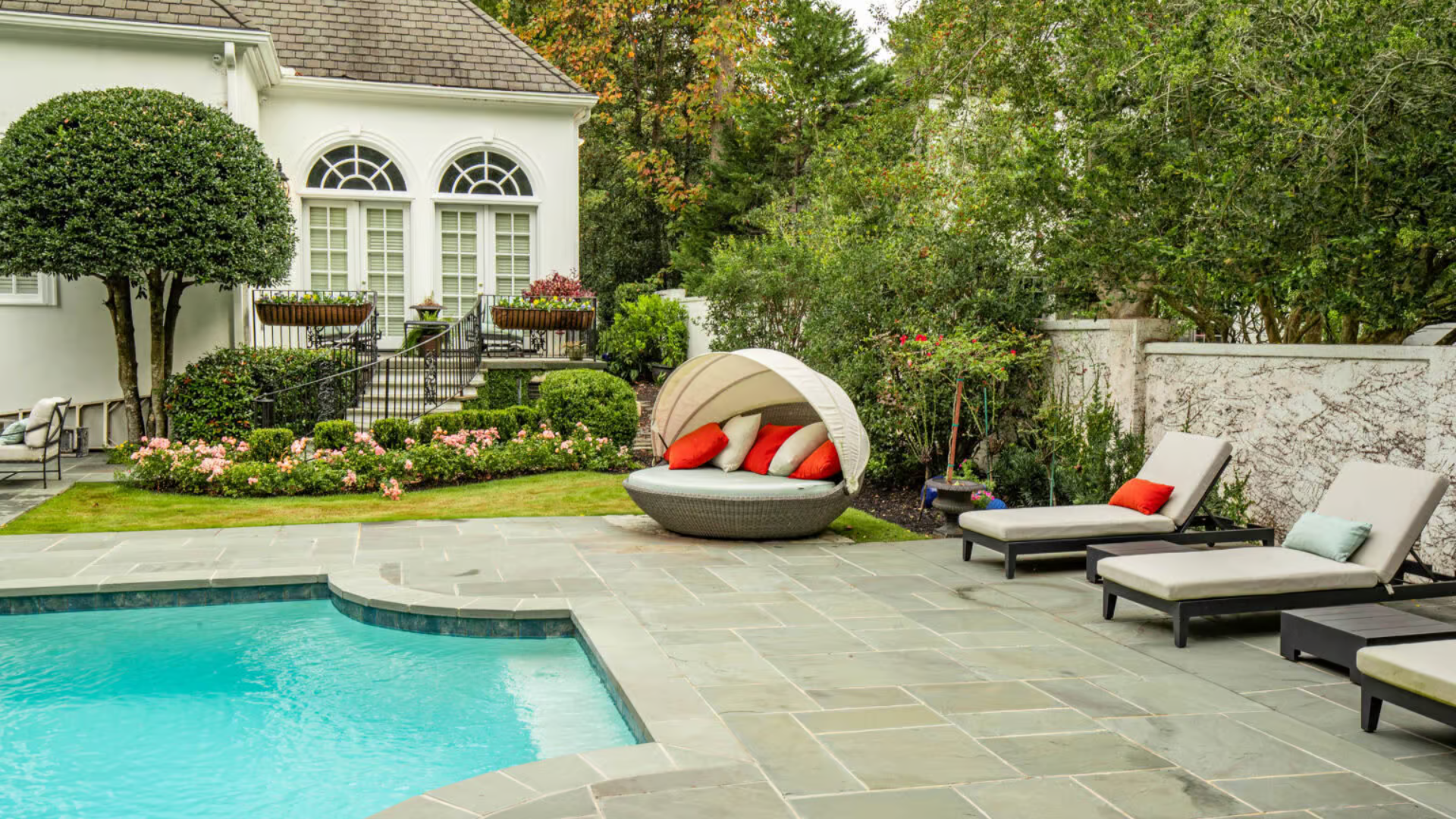 Pool terrace with lounge chairs and planting — outdoor living by Oak and Stone Landscaping