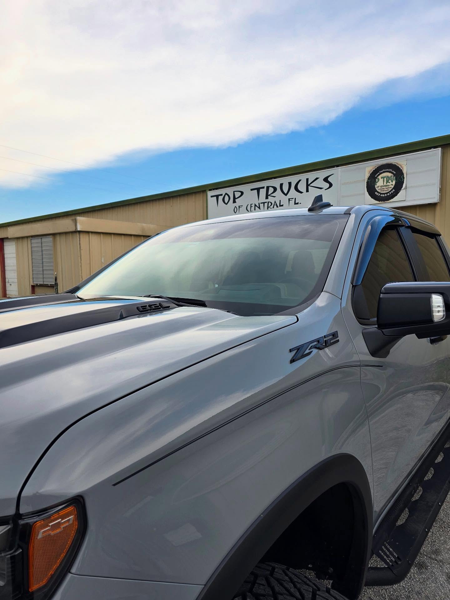 Gray Chevy Silverado ZR2 outside the Top Trucks shop