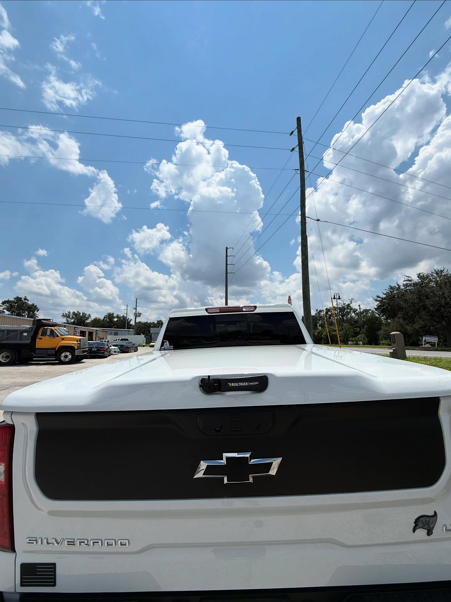 Silverado tailgate with a RealTruck bed cover, built at Top Trucks of Central Florida in Longwood, FL