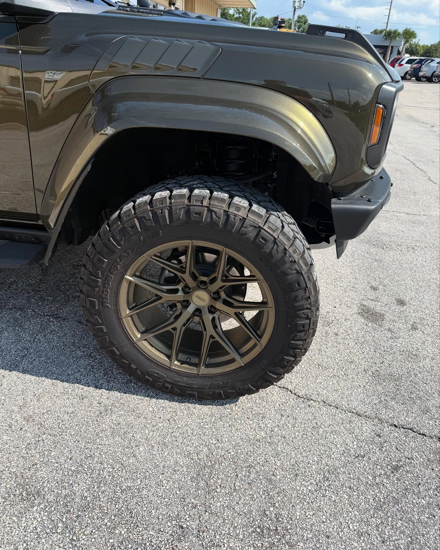 Bronze wheel with an all-terrain tire, built at Top Trucks of Central Florida in Longwood, FL