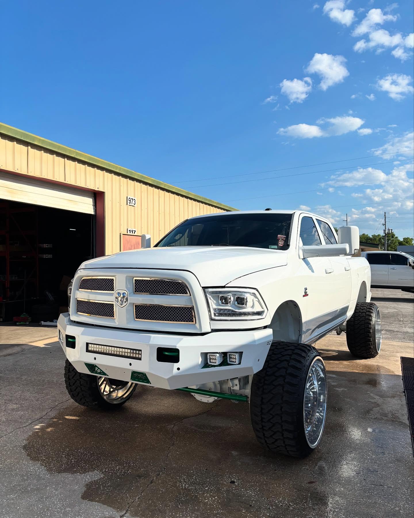 Lifted white Ram 2500 on chrome wheels, built at Top Trucks of Central Florida in Longwood, FL