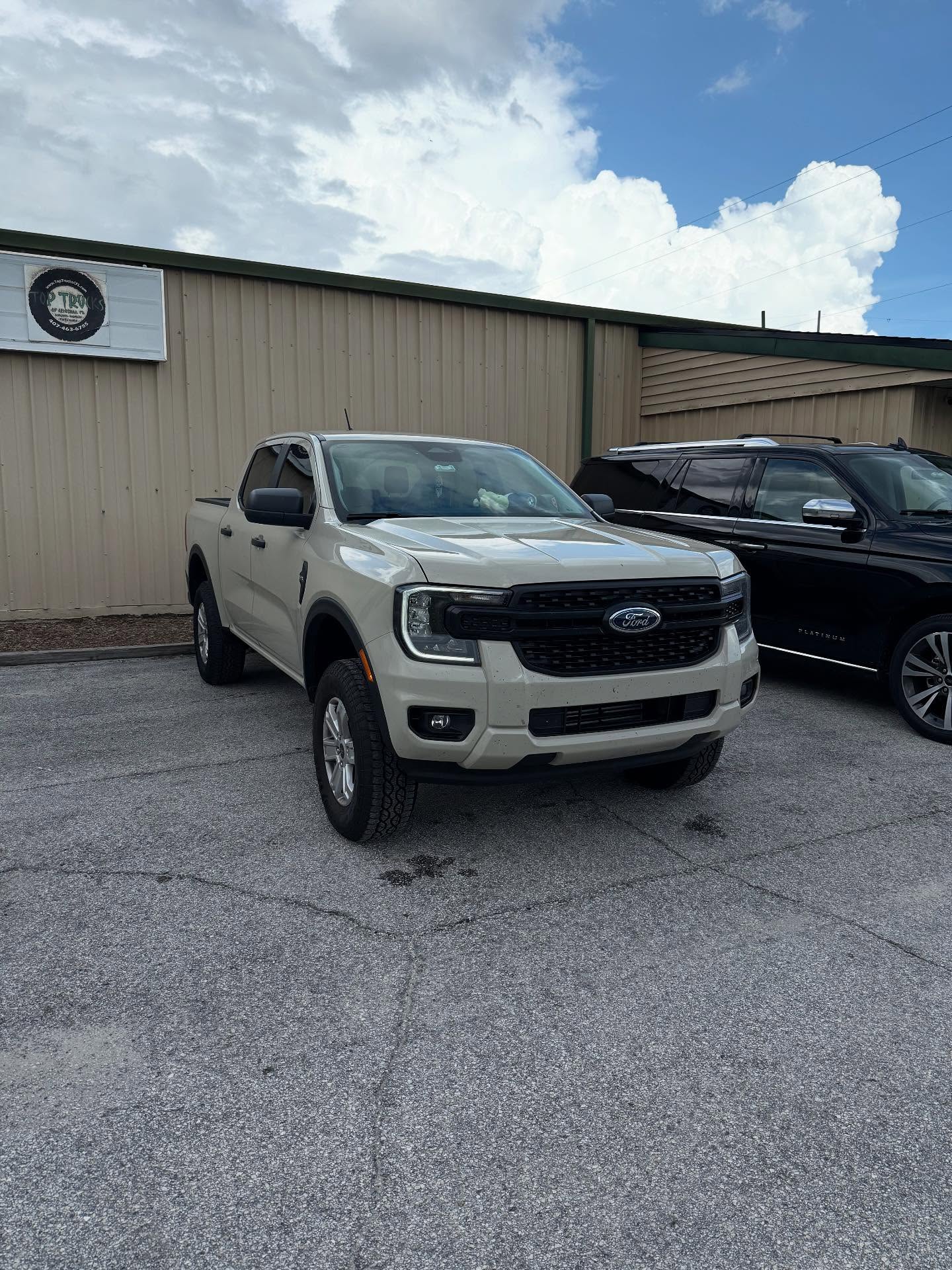White Ford Ranger outside the Top Trucks shop