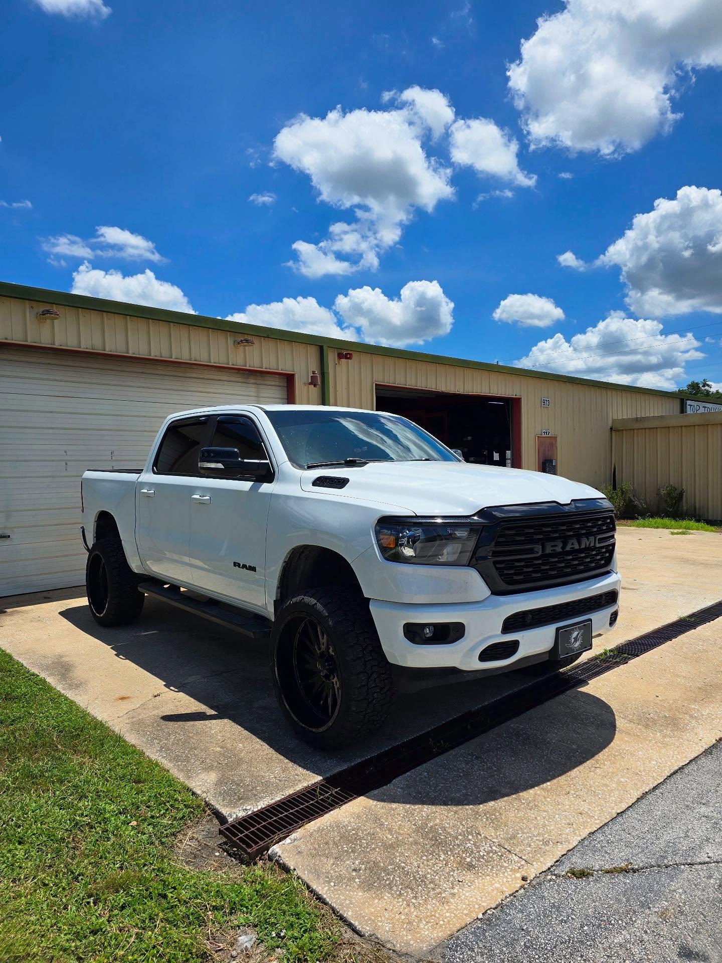 White Ram 1500 outside the Top Trucks shop