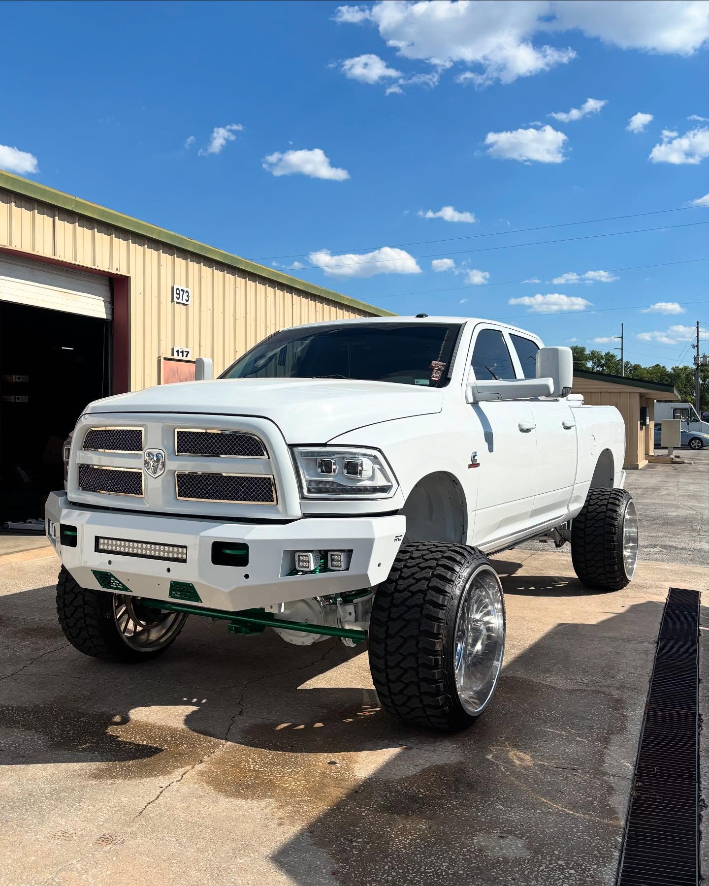 White Ram 2500 HD with an aftermarket front bumper and lift