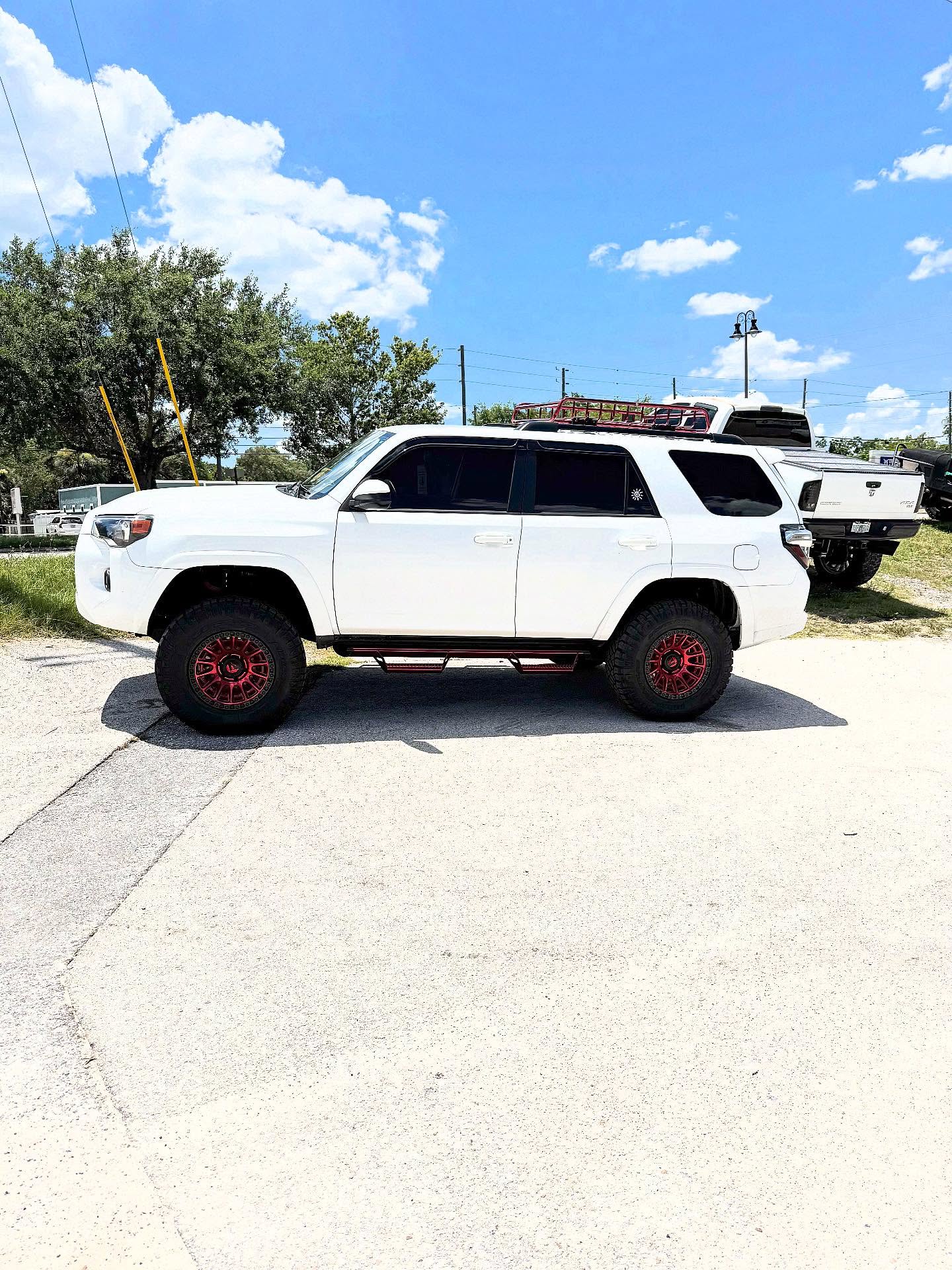 White Toyota 4Runner on red wheels