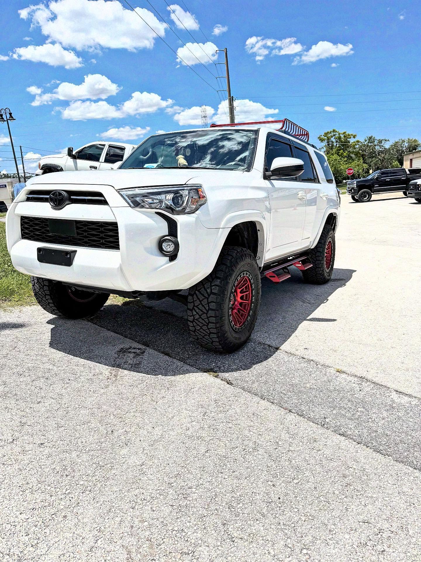 Lifted Toyota 4Runner on red wheels, built at Top Trucks of Central Florida in Longwood, FL