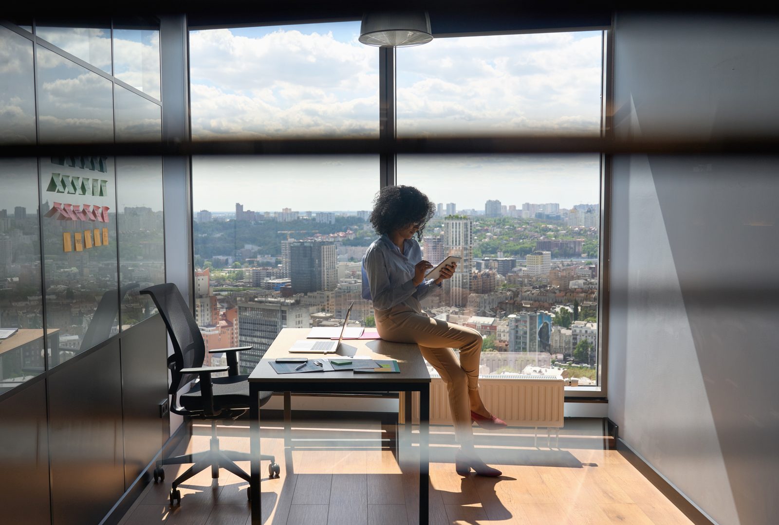 A leader sits alone in a quiet glass-walled office, weighing the decision after a program that worked in the room and faded once the system pulled everyone back