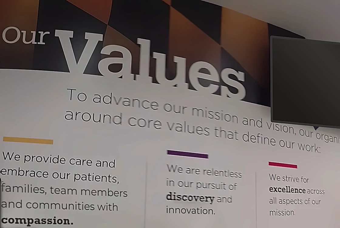 A values wall in a lobby, the stated culture written out under Our Values