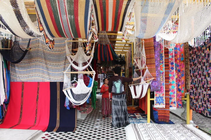 A woman is shopping at a local textile shop in Guatemala