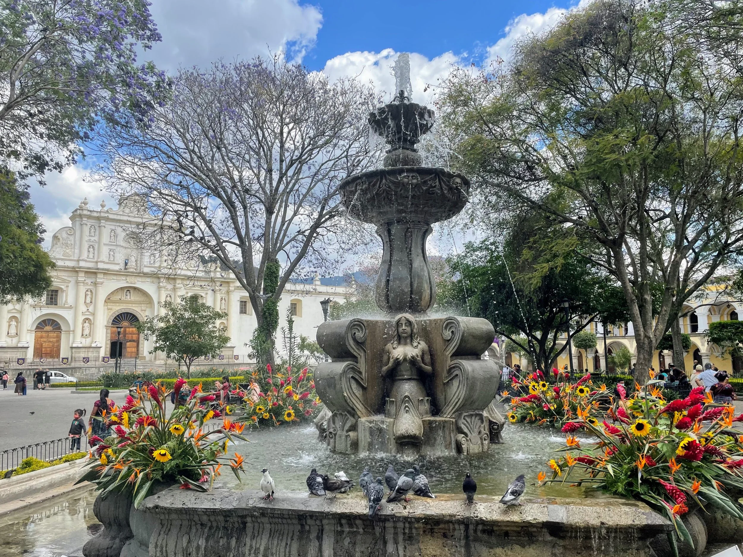 A white church and fountain in downtown Antigua, Guatemala
