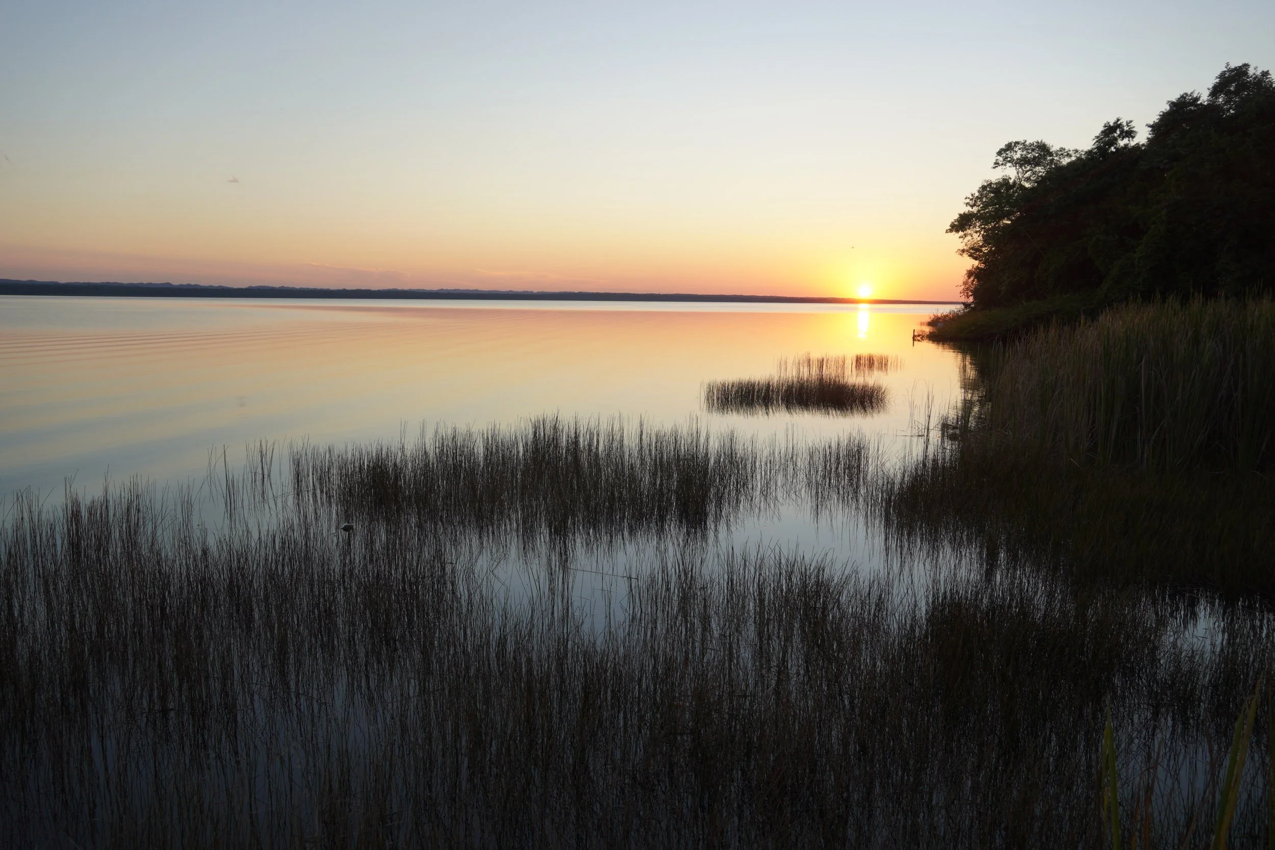 A sunset from the waters edge of Lake Peten Itza in Peten Guatemala