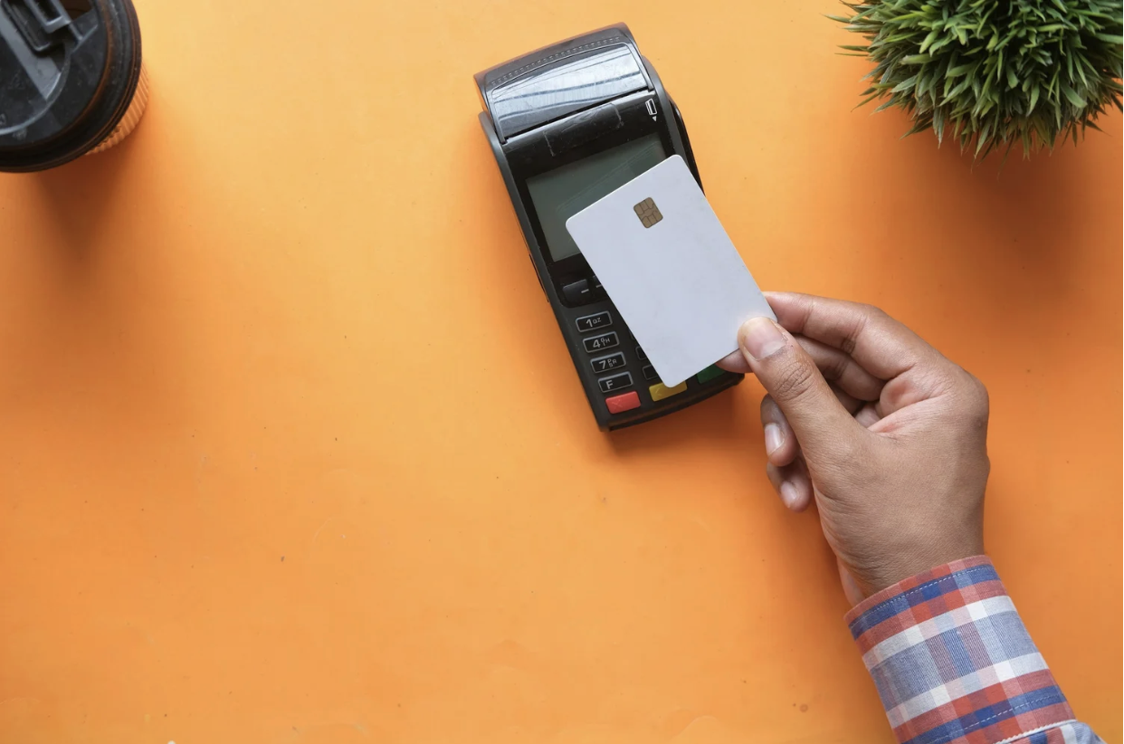 A man is paying using a credit card machine while traveling to Guatemala