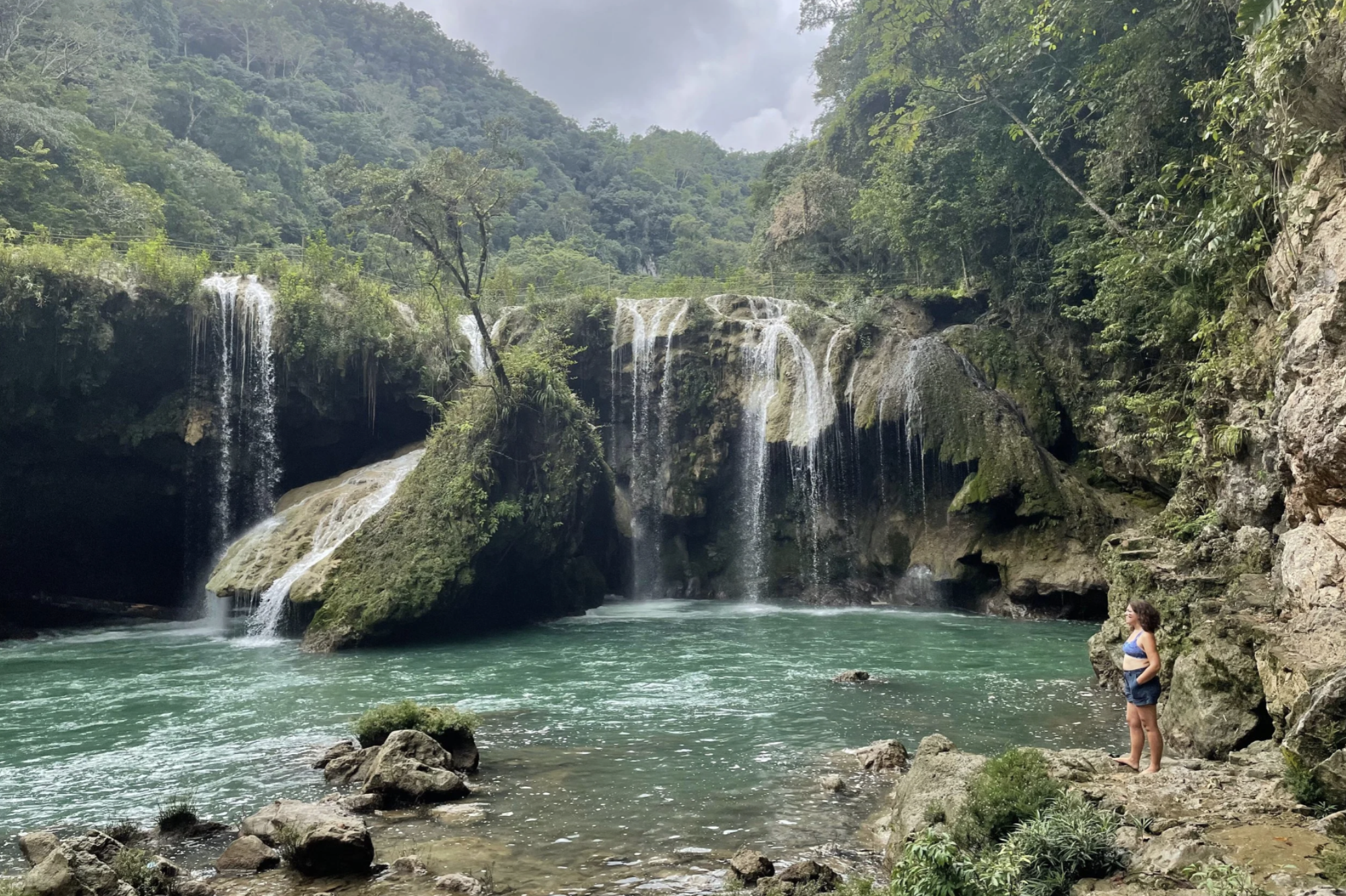 A woman stands near the waterfalls of Semuc Champey in Alta Verapaz, Guatemala