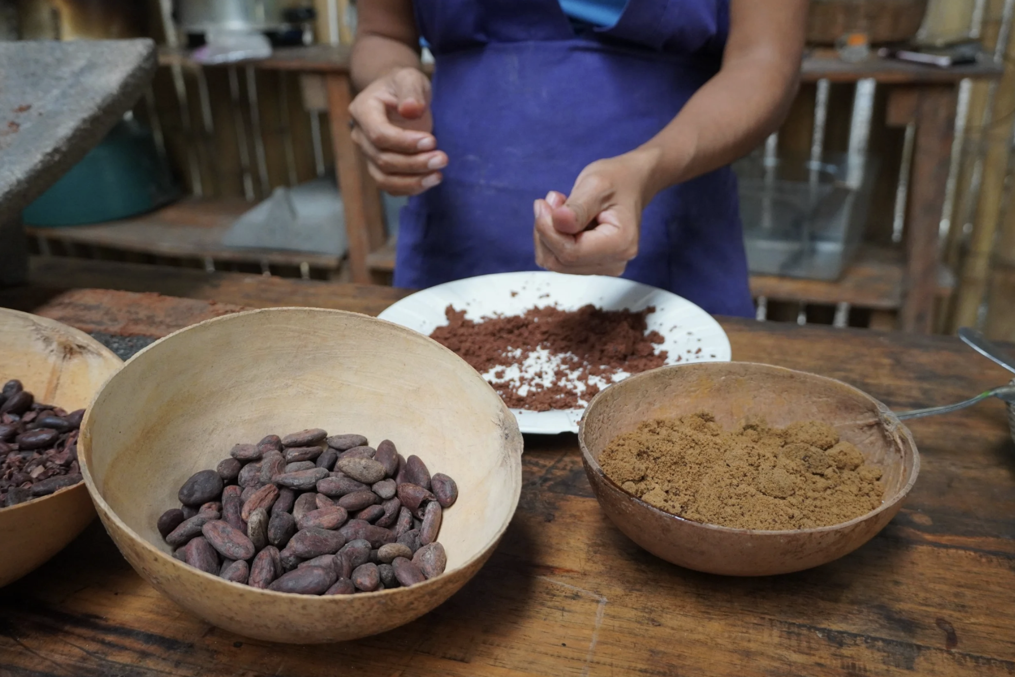 A woman is showing the chocolate making process from bean to bar in Guatemala.