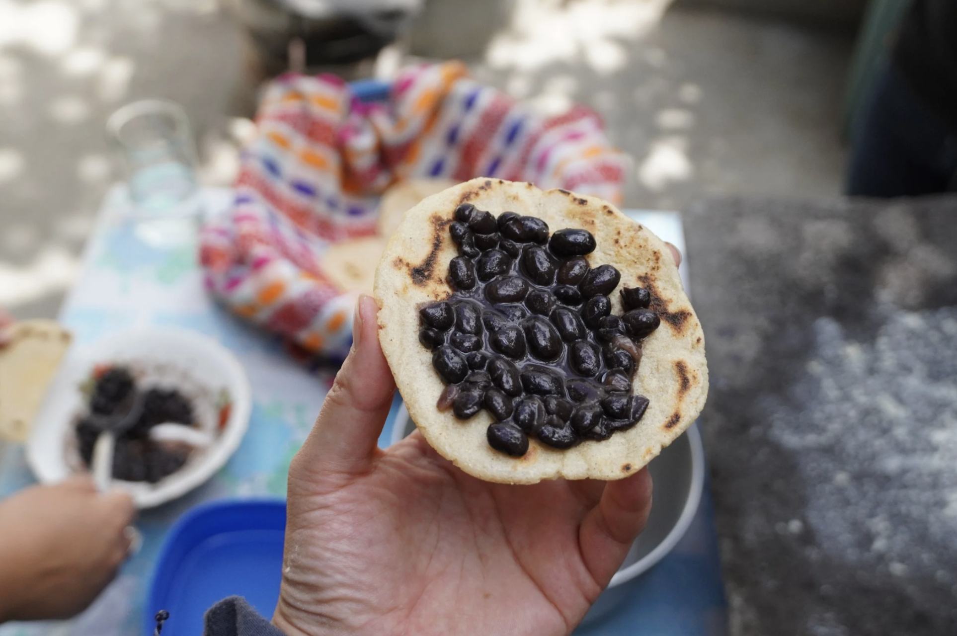 An example of Guatemalan street food is this freshly made tortilla with black beans.